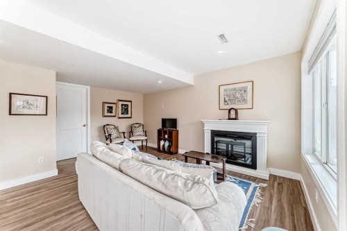 68 Strathlea Close Sw, Calgary, AB - Indoor Photo Showing Living Room With Fireplace