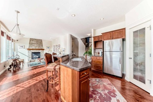 68 Strathlea Close Sw, Calgary, AB - Indoor Photo Showing Kitchen With Fireplace