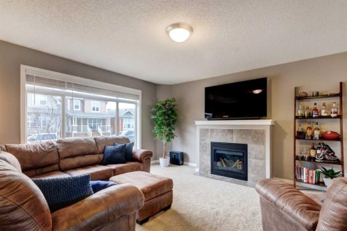 207 Cranford Crescent Se, Calgary, AB - Indoor Photo Showing Living Room With Fireplace