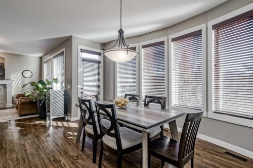 60 Sheep River Heights, Okotoks, AB - Indoor Photo Showing Dining Room With Fireplace