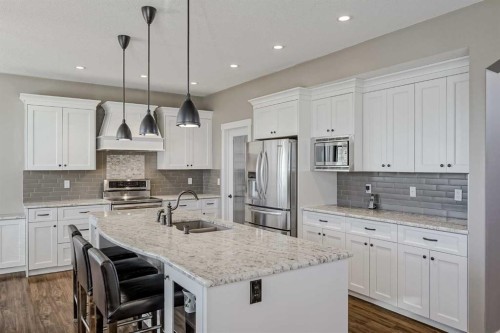60 Sheep River Heights, Okotoks, AB - Indoor Photo Showing Kitchen With Double Sink With Upgraded Kitchen