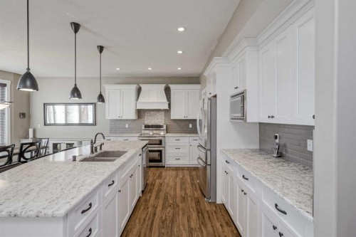 60 Sheep River Heights, Okotoks, AB - Indoor Photo Showing Kitchen With Double Sink With Upgraded Kitchen