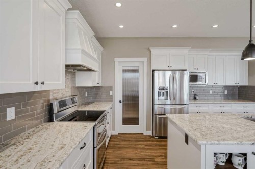 60 Sheep River Heights, Okotoks, AB - Indoor Photo Showing Kitchen With Upgraded Kitchen