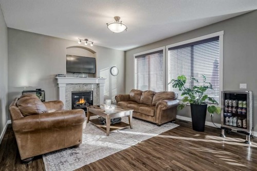 60 Sheep River Heights, Okotoks, AB - Indoor Photo Showing Living Room With Fireplace