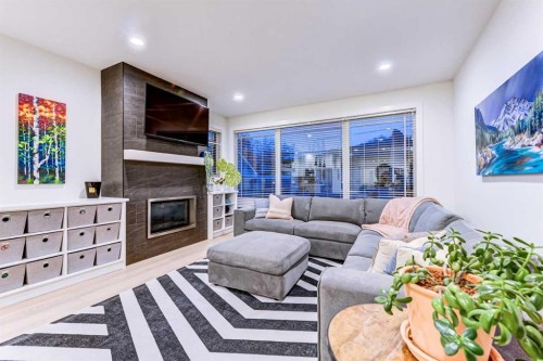 116 34A Street Nw, Calgary, AB - Indoor Photo Showing Living Room With Fireplace