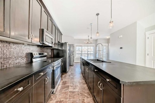 397 Rainbow Falls Drive, Chestermere, AB - Indoor Photo Showing Kitchen With Double Sink With Upgraded Kitchen
