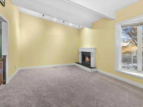 107 Woodford Crescent Sw, Calgary, AB - Indoor With Fireplace