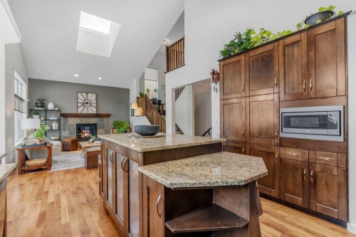 505 Discovery Ridge Boulevard Sw, Calgary, AB - Indoor Photo Showing Kitchen With Fireplace