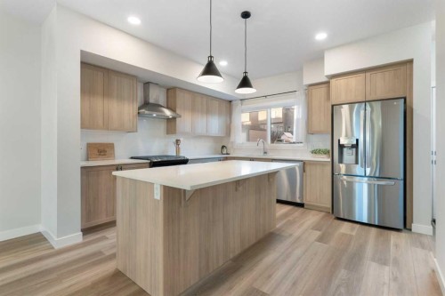 99 Edith Passage Nw, Calgary, AB - Indoor Photo Showing Kitchen With Upgraded Kitchen