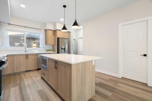 99 Edith Passage Nw, Calgary, AB - Indoor Photo Showing Kitchen With Upgraded Kitchen