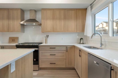 99 Edith Passage Nw, Calgary, AB - Indoor Photo Showing Kitchen With Double Sink