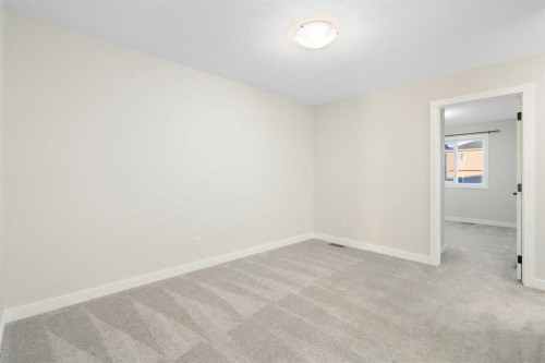99 Edith Passage Nw, Calgary, AB - Indoor Photo Showing Other Room
