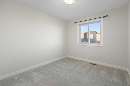 99 Edith Passage Nw, Calgary, AB - Indoor Photo Showing Other Room