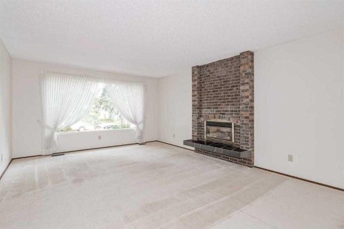 330 Oakwood Place Sw, Calgary, AB - Indoor Photo Showing Living Room With Fireplace