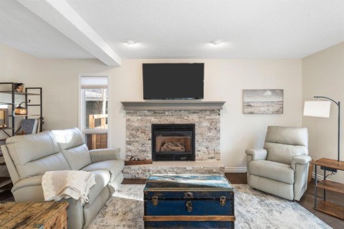 209 Hawkstone Drive Nw, Calgary, AB - Indoor Photo Showing Living Room With Fireplace