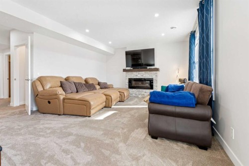 548 Cranbrook Gardens Se, Calgary, AB - Indoor Photo Showing Living Room With Fireplace