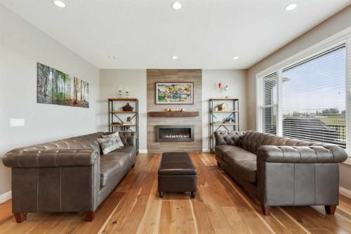 260 Boulder Creek Crescent Se, Langdon, AB - Indoor Photo Showing Living Room With Fireplace