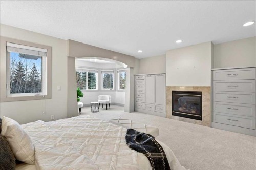 10 Discovery Ridge Way Sw, Calgary, AB - Indoor Photo Showing Bedroom With Fireplace
