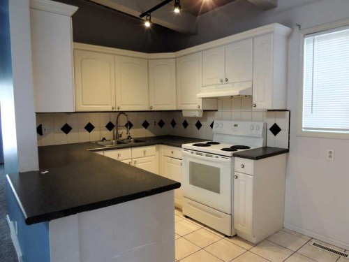 2713 Canmore Road Nw, Calgary, AB - Indoor Photo Showing Kitchen With Double Sink