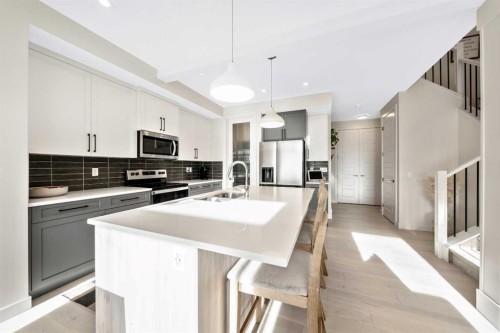 84 Mill Road, Cochrane, AB - Indoor Photo Showing Kitchen With Stainless Steel Kitchen With Double Sink With Upgraded Kitchen