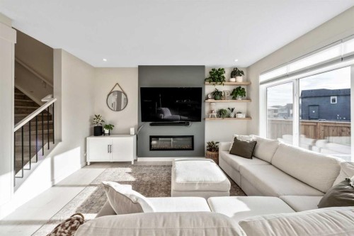 84 Mill Road, Cochrane, AB - Indoor Photo Showing Living Room With Fireplace