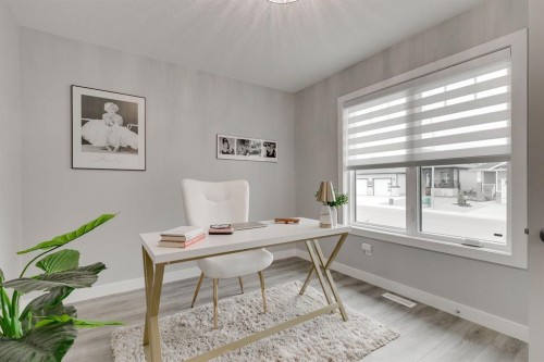 185 Riverwood Crescent, Diamond Valley, AB - Indoor Photo Showing Living Room With Fireplace