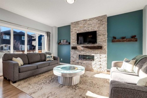36 Sundown Common, Cochrane, AB - Indoor Photo Showing Living Room With Fireplace