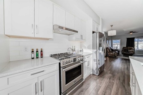 2306 Jumping Pound Common, Cochrane, AB - Indoor Photo Showing Kitchen With Upgraded Kitchen