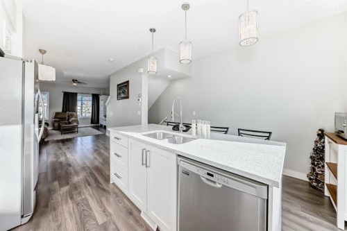 2306 Jumping Pound Common, Cochrane, AB - Indoor Photo Showing Kitchen With Double Sink