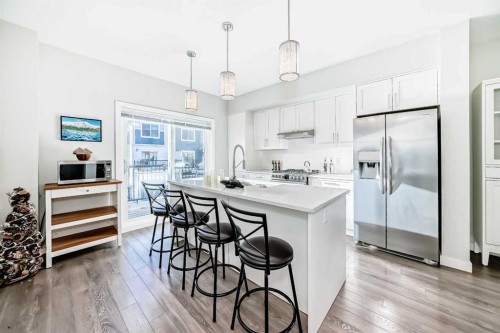 2306 Jumping Pound Common, Cochrane, AB - Indoor Photo Showing Kitchen With Upgraded Kitchen