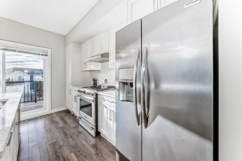 2306 Jumping Pound Common, Cochrane, AB - Indoor Photo Showing Kitchen With Upgraded Kitchen