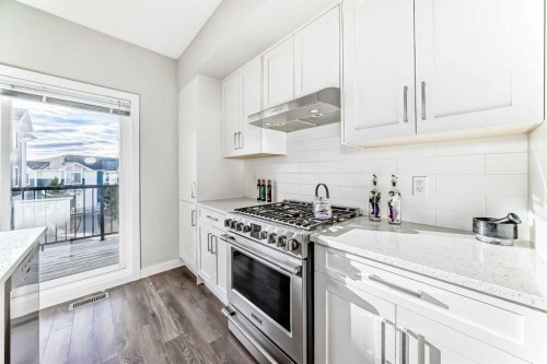 2306 Jumping Pound Common, Cochrane, AB - Indoor Photo Showing Kitchen With Upgraded Kitchen