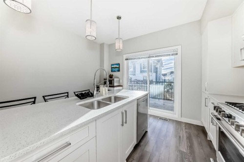 2306 Jumping Pound Common, Cochrane, AB - Indoor Photo Showing Kitchen With Double Sink With Upgraded Kitchen