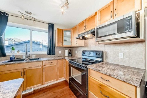 47 Bridlecrest Road Sw, Calgary, AB - Indoor Photo Showing Kitchen With Double Sink