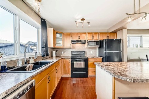 47 Bridlecrest Road Sw, Calgary, AB - Indoor Photo Showing Kitchen With Double Sink