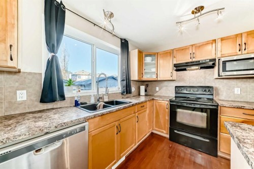 47 Bridlecrest Road Sw, Calgary, AB - Indoor Photo Showing Kitchen With Double Sink