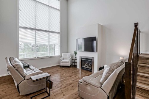 225 Kingsmere Cove Se, Airdrie, AB - Indoor Photo Showing Living Room With Fireplace