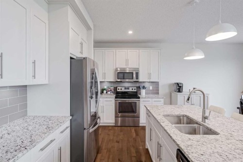 225 Kingsmere Cove Se, Airdrie, AB - Indoor Photo Showing Kitchen With Double Sink With Upgraded Kitchen