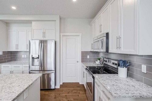 225 Kingsmere Cove Se, Airdrie, AB - Indoor Photo Showing Kitchen With Upgraded Kitchen