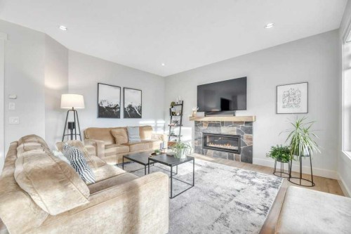 225 Discovery Ridge Way Sw, Calgary, AB - Indoor Photo Showing Living Room With Fireplace