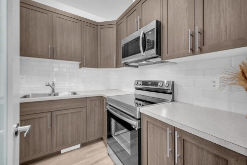 151 Carringham Way Nw, Calgary, AB - Indoor Photo Showing Kitchen With Double Sink