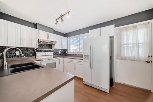 213 Prestwick Circle Se, Calgary, AB - Indoor Photo Showing Kitchen With Double Sink