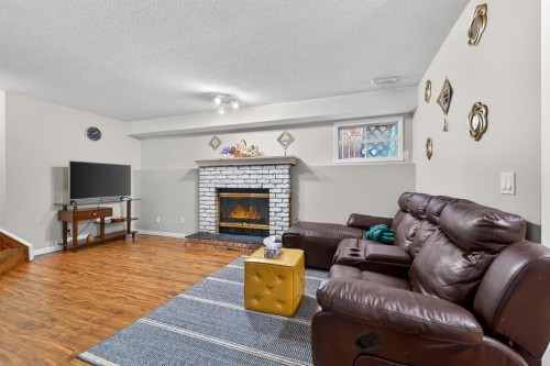 139 Castledale Way Ne, Calgary, AB - Indoor Photo Showing Living Room With Fireplace