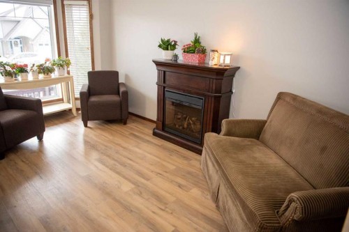 283 Highland Circle, Strathmore, AB - Indoor Photo Showing Living Room With Fireplace