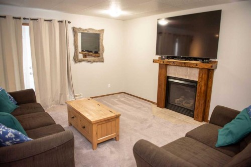 283 Highland Circle, Strathmore, AB - Indoor Photo Showing Living Room With Fireplace