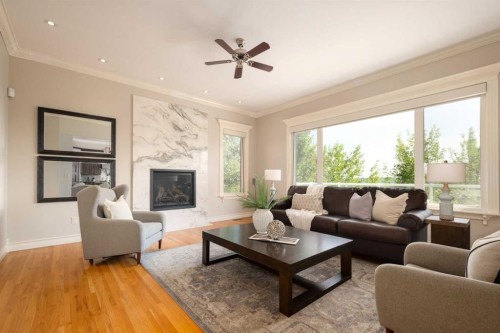 57 Slopes Point Sw, Calgary, AB - Indoor Photo Showing Living Room With Fireplace