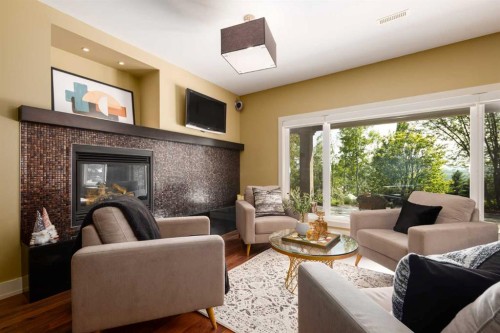 57 Slopes Point Sw, Calgary, AB - Indoor Photo Showing Living Room With Fireplace