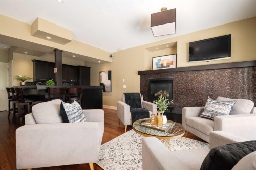 57 Slopes Point Sw, Calgary, AB - Indoor Photo Showing Living Room With Fireplace
