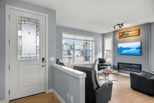 3 Sundown Manor, Cochrane, AB - Indoor Photo Showing Living Room With Fireplace