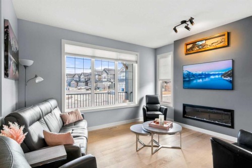 3 Sundown Manor, Cochrane, AB - Indoor Photo Showing Living Room With Fireplace